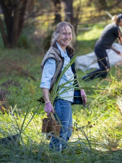 Jane Ough planting native seedlings at the QEII covenant in Carterton.